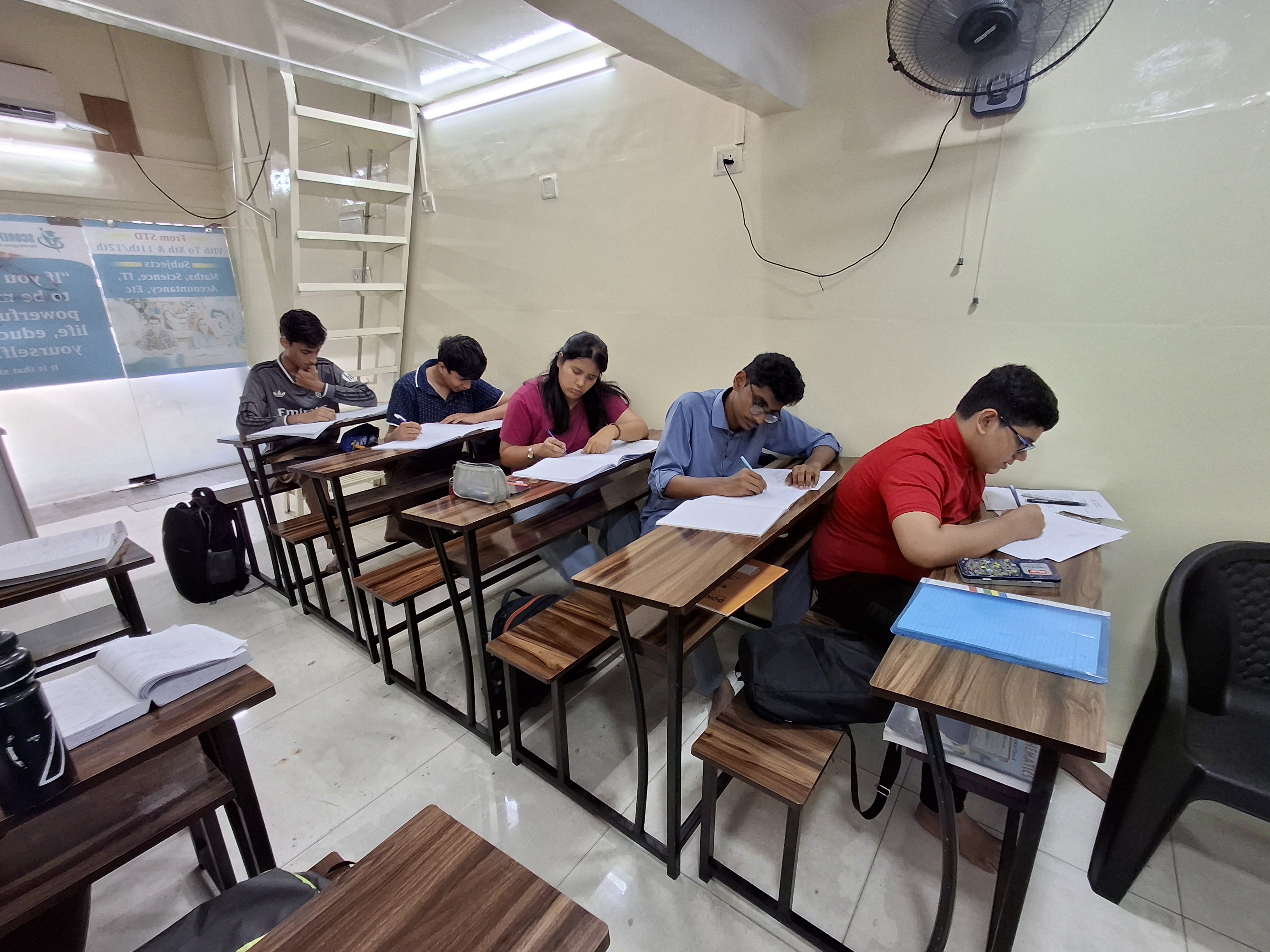 Indian student studying math and science in classroom